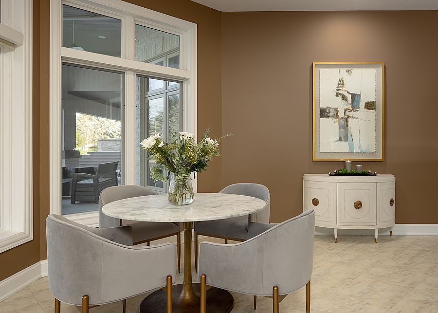 A backdrop of mocha paint contrast with the light floor and furniture.